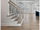 A staircase features modern iron railings, light wood flooring, and recessed lighting at 4024 Hosch Retreat Dr, Buford, GA 30519