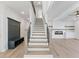 Bright entryway featuring a staircase, custom built-in storage, and an open living space with a fireplace at 4024 Hosch Retreat Dr, Buford, GA 30519