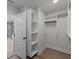 Bright walk-in closet features white shelving and black hardware, with easy access to bathroom at 4024 Hosch Retreat Dr, Buford, GA 30519