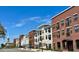 Modern apartment buildings line the street under a clear blue sky, showcasing attractive architecture at 16 Jacobs Farm Ln # 8, Lawrenceville, GA 30045