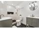 Modern bathroom with double vanity, herringbone backsplash, and glass-enclosed shower at 2802 Palm Dr, Atlanta, GA 30344