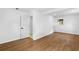 Basement with wood flooring, white walls, and a door to another room with great sunlight from a window at 6660 Hidden Brook Trl, Atlanta, GA 30349