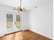 Bright dining area with hardwood floors and glass doors leading to outdoor patio at 6660 Hidden Brook Trl, Atlanta, GA 30349