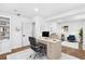 Bright office features wood floors, built-in shelving, and an oversized desk with a black adjustable chair at 6660 Hidden Brook Trl, Atlanta, GA 30349