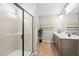 Bathroom featuring a glass shower, a double vanity, tile floors, and modern lighting fixtures at 720 Shetland Trl, Cartersville, GA 30121