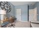 Stylish bedroom with a desk, chair, and a clock on the wall; the walls are a pleasant shade of blue at 720 Shetland Trl, Cartersville, GA 30121