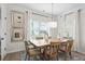 Lovely dining room with a wooden table and chairs, a modern light fixture, and lots of natural light at 720 Shetland Trl, Cartersville, GA 30121