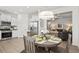 A well-lit kitchen with stainless steel appliances, white cabinetry, and an adjacent dining area at 720 Shetland Trl, Cartersville, GA 30121