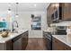 This kitchen includes stainless steel appliances, sleek countertops, and white subway tile backsplash at 720 Shetland Trl, Cartersville, GA 30121