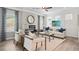 Bright living room featuring wood floors, a fireplace, a ceiling fan, neutral walls, and lots of comfortable seating at 720 Shetland Trl, Cartersville, GA 30121