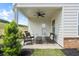 Relaxing covered patio area features an outdoor ceiling fan and views of the landscaped backyard at 720 Shetland Trl, Cartersville, GA 30121