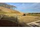 Grassy community playground featuring a slide, swings, mature trees, and a fenced perimeter at 720 Shetland Trl, Cartersville, GA 30121