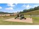 Neighborhood playground in a level grassy area featuring mature trees and ample parking nearby at 720 Shetland Trl, Cartersville, GA 30121