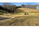 Wide view of fenced playground and benches in the community, with a large hill in the background at 720 Shetland Trl, Cartersville, GA 30121