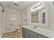 Bathroom featuring a single sink vanity, with built-in storage, and a large mirror above the sink at 1408 Lake Paradise Rd, Villa Rica, GA 30180