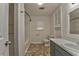 Bathroom featuring a single sink vanity, with built-in storage, and a large mirror above the sink at 1408 Lake Paradise Rd, Villa Rica, GA 30180