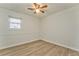 A cozy bedroom featuring a ceiling fan, window with blinds, and neutral walls creating a serene atmosphere at 1408 Lake Paradise Rd, Villa Rica, GA 30180