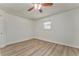 Bedroom featuring new wood flooring, neutral walls, ceiling fan, and windows with blinds at 1408 Lake Paradise Rd, Villa Rica, GA 30180