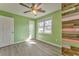 Unique bedroom featuring wood-look flooring, multiple windows and a rustic accent wall at 1408 Lake Paradise Rd, Villa Rica, GA 30180