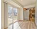 Bright dining area featuring wood floors, sliding door access to deck, and natural light flowing into the adjacent kitchen at 1408 Lake Paradise Rd, Villa Rica, GA 30180