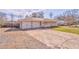 Single-story home features a two-car garage with a long driveway and cozy front porch at 1408 Lake Paradise Rd, Villa Rica, GA 30180