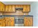 Kitchen featuring stainless steel appliances, wooden cabinetry, and sleek black countertops at 1408 Lake Paradise Rd, Villa Rica, GA 30180