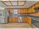 Bright kitchen with stainless steel appliances, wooden cabinets, and a unique coffered ceiling at 1408 Lake Paradise Rd, Villa Rica, GA 30180