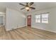 Bright living room with ceiling fan, wood-look floors, and a large window for ample natural light at 1408 Lake Paradise Rd, Villa Rica, GA 30180