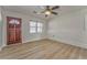Bright living room features a ceiling fan, wood-look floors, and a charming brick accent wall at 1408 Lake Paradise Rd, Villa Rica, GA 30180
