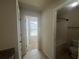 Bathroom with a bathtub, toilet, and window for natural light at 651 Deer Springs Way, Loganville, GA 30052