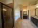 The bathroom features granite countertops, dual vanity sinks, dark cabinetry, shower and a soaking tub at 651 Deer Springs Way, Loganville, GA 30052