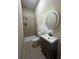 Bathroom with shower, tile surround, updated sink, vanity and modern oval mirror at 651 Deer Springs Way, Loganville, GA 30052