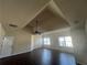 Spacious bedroom featuring tray ceiling, ceiling fan, and windows providing natural light at 651 Deer Springs Way, Loganville, GA 30052