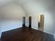 Open bedroom featuring hardwood floors, neutral walls, and a private bathroom entrance at 651 Deer Springs Way, Loganville, GA 30052
