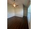 A bright bedroom featuring a ceiling fan, hardwood floors and a glimpse of a walk-in closet at 651 Deer Springs Way, Loganville, GA 30052