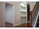 Inviting entryway showcasing hardwood floors, staircase with wrought iron spindles, and custom built-in shelving at 651 Deer Springs Way, Loganville, GA 30052