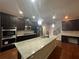 Gourmet kitchen with a large island, granite countertops, and stainless steel appliances at 651 Deer Springs Way, Loganville, GA 30052