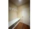 Mudroom featuring a wooden floor, a white bench, and coat hooks at 651 Deer Springs Way, Loganville, GA 30052