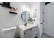 Bright bathroom featuring a round mirror, black hardware, decor shelves, and white marble vanity at 2700 Pine Tree Ne Rd # 4006, Atlanta, GA 30324