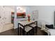 Bright dining area with modern table, chairs, and stylish decor, plus views into an open-concept kitchen at 2700 Pine Tree Ne Rd # 4006, Atlanta, GA 30324