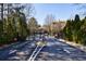 Carrington Park community entrance gate with mature trees, blue skies, and well-maintained landscaping at 2700 Pine Tree Ne Rd # 4006, Atlanta, GA 30324