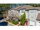 Exterior view of the townhome showcasing multiple levels, grey siding, brick accents, and attached garages at 2700 Pine Tree Ne Rd # 4006, Atlanta, GA 30324