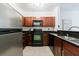 Kitchen featuring granite countertops, dark wood cabinets, and modern black appliances at 2700 Pine Tree Ne Rd # 4006, Atlanta, GA 30324