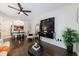 Cozy living room features dark wood floors, modern wall-mounted TV, and an open concept design at 2700 Pine Tree Ne Rd # 4006, Atlanta, GA 30324