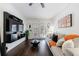 Inviting living room with a large sofa, dark wood floors, and a stylish wall-mounted media center at 2700 Pine Tree Ne Rd # 4006, Atlanta, GA 30324