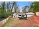 Back exterior of home featuring a covered patio with a fenced yard and mature landscaping at 3457 Scenic Dr, East Point, GA 30344