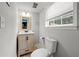 Updated half bathroom with modern vanity, light fixture, and toilet at 3457 Scenic Dr, East Point, GA 30344