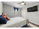 Bedroom features ceiling fan, a large wall-mounted television and natural light at 3457 Scenic Dr, East Point, GA 30344
