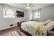Bedroom with two windows, a large bed, hardwood floors, and a desk at 3457 Scenic Dr, East Point, GA 30344