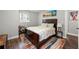 Cozy bedroom with a large bed, wood floors, and a desk at 3457 Scenic Dr, East Point, GA 30344
